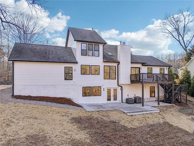 back of property featuring a wooden deck, a patio area, french doors, and central air condition unit