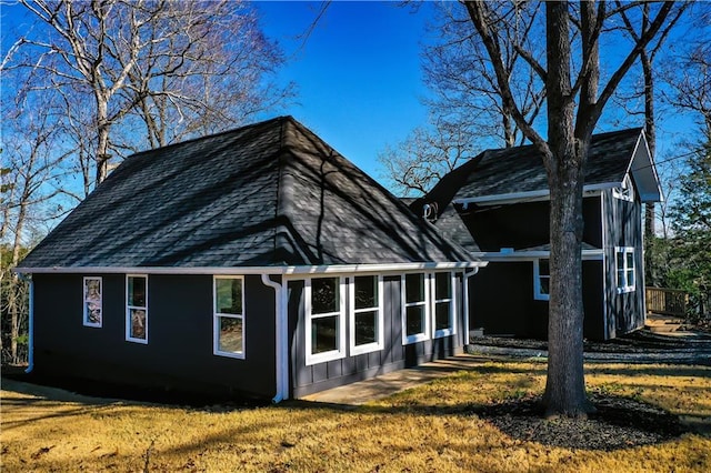 back of property featuring a lawn