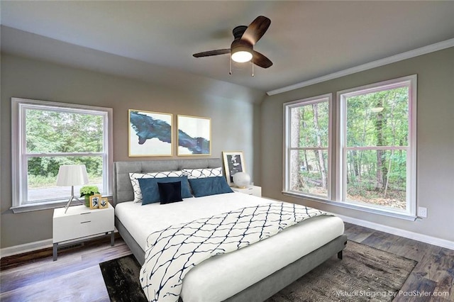 bedroom with ceiling fan, ornamental molding, and hardwood / wood-style flooring