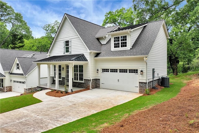 200 College Ave, Commerce, GA 30529 - view of front of house with a porch, stone siding, roof with shingles, concrete driveway, and central air condition unit