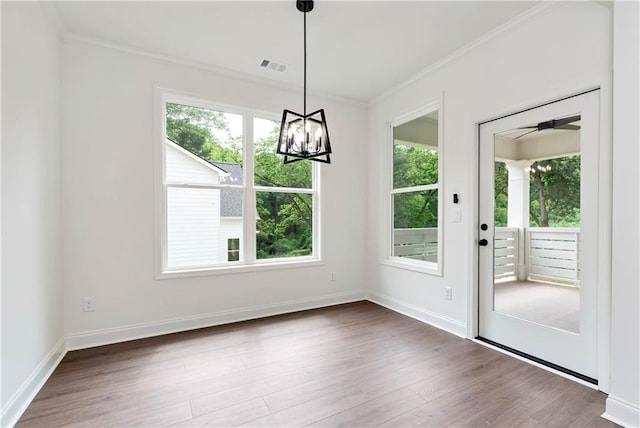200 College Ave, Commerce, GA 30529 - unfurnished dining area featuring crown molding, wood finished floors, a chandelier, and baseboards