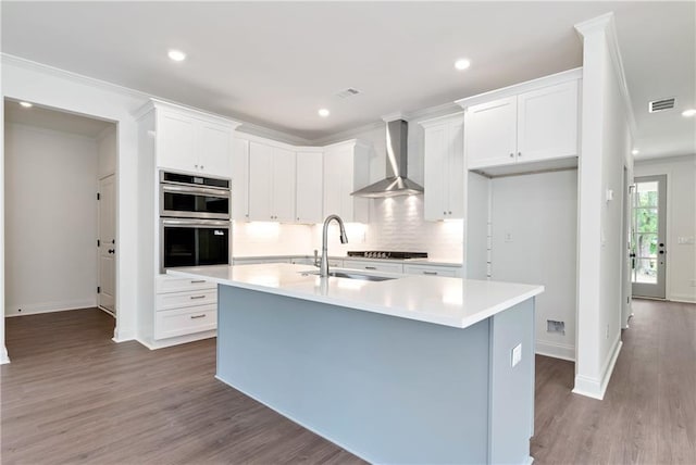 200 College Ave, Commerce, GA 30529 - kitchen featuring wall chimney range hood, a sink, tasteful backsplash, baseboards, and crown molding