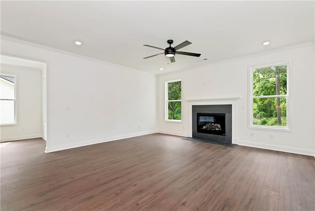 200 College Ave, Commerce, GA 30529 - unfurnished living room with plenty of natural light, dark wood finished floors, a glass covered fireplace, crown molding, and baseboards