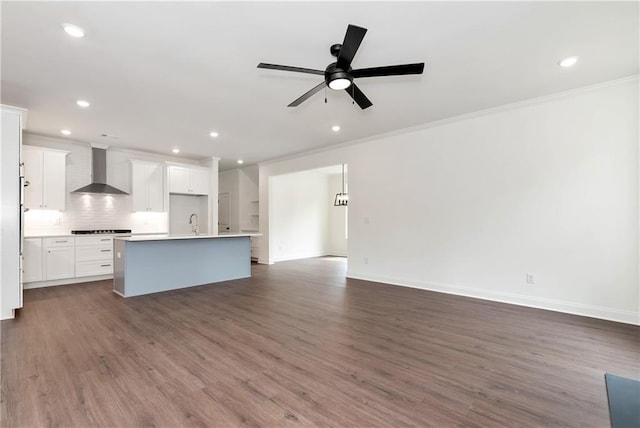 200 College Ave, Commerce, GA 30529 - unfurnished living room featuring ornamental molding, recessed lighting, a ceiling fan, dark wood-style flooring, and a sink