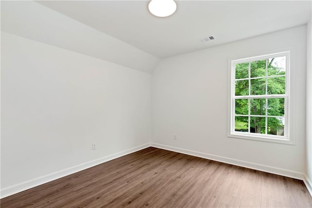 200 College Ave, Commerce, GA 30529 - spare room featuring baseboards, dark wood-style floors, and vaulted ceiling