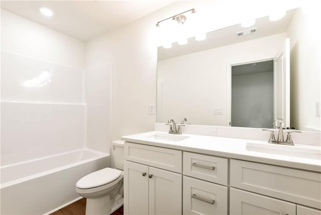 200 College Ave, Commerce, GA 30529 - full bath with toilet, double vanity, and wood finished floors