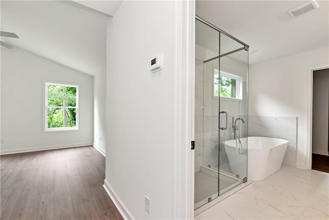 200 College Ave, Commerce, GA 30529 - full bathroom with a freestanding tub, a stall shower, a ceiling fan, lofted ceiling, and marble finish floors