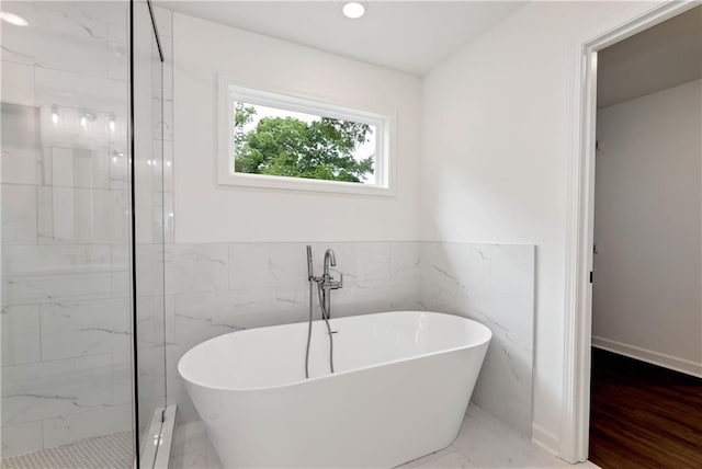 200 College Ave, Commerce, GA 30529 - full bath featuring a soaking tub, a marble finish shower, and tile walls