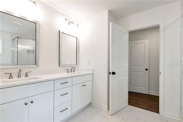 200 College Ave, Commerce, GA 30529 - bathroom featuring marble finish flooring, a shower stall, double vanity, and baseboards