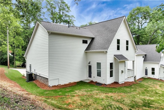 200 College Ave, Commerce, GA 30529 - back of house featuring central AC unit, a lawn, and a shingled roof