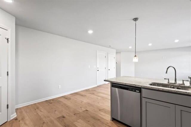 kitchen featuring gray cabinets, kitchen peninsula, light hardwood / wood-style floors, and appliances with stainless steel finishes