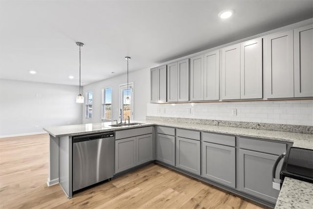 kitchen featuring stainless steel dishwasher, gray cabinetry, sink, light hardwood / wood-style floors, and hanging light fixtures