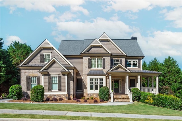 craftsman-style house with a porch and a front lawn