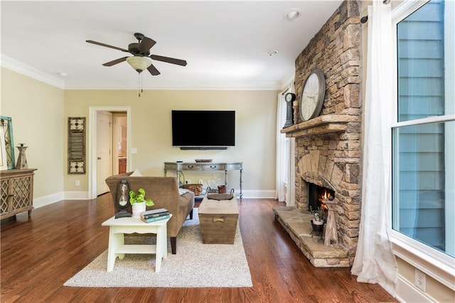 living room featuring ceiling fan, a fireplace, dark wood-type flooring, and ornamental molding