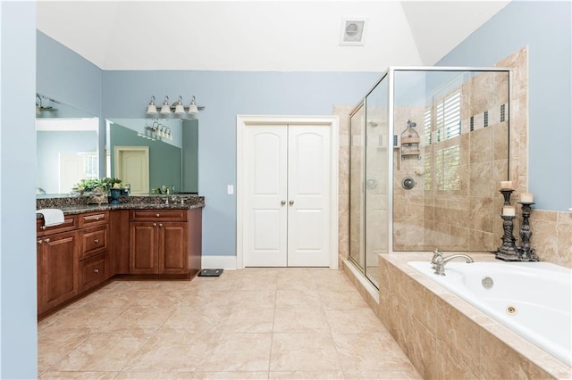 bathroom featuring plus walk in shower, vanity, tile patterned floors, and vaulted ceiling