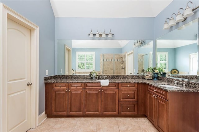 bathroom featuring vanity, tile patterned floors, and walk in shower