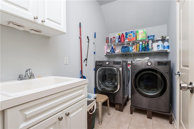 laundry room with separate washer and dryer, sink, light tile patterned flooring, and cabinets