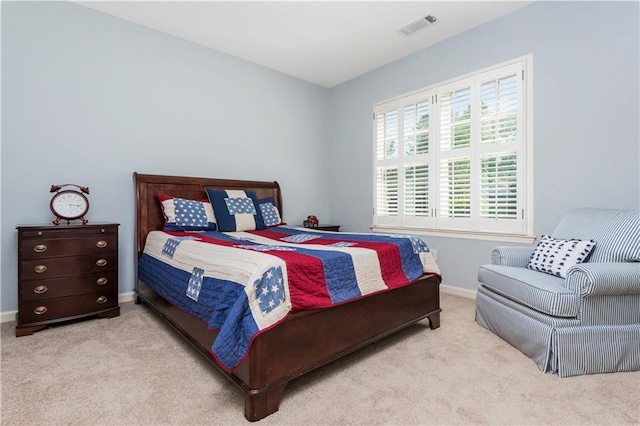 bedroom featuring light carpet