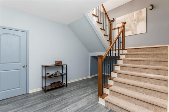 staircase with hardwood / wood-style floors