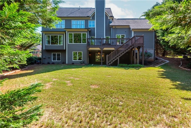 back of property with a lawn and a wooden deck