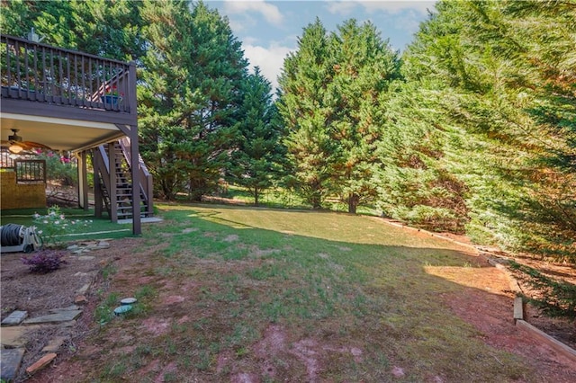 view of yard featuring ceiling fan and a wooden deck