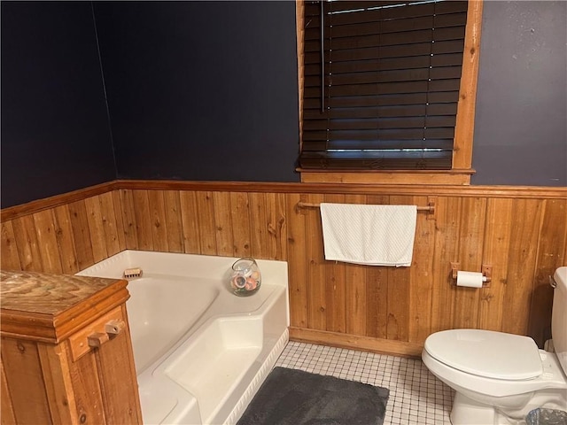 6245 Bannister Rd, Cumming, GA 30028 - full bath with toilet, wainscoting, a garden tub, and tile patterned flooring
