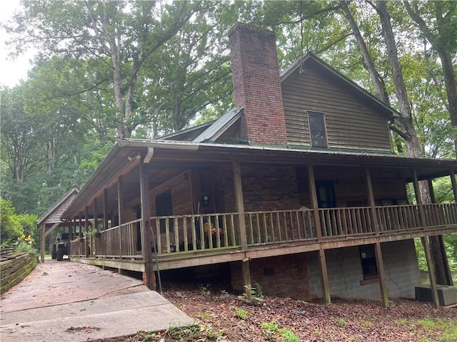 6245 Bannister Rd, Cumming, GA 30028 - view of side of home featuring metal roof and a chimney
