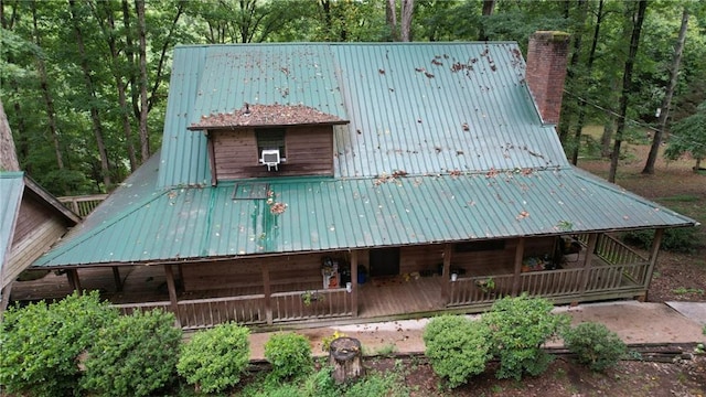6245 Bannister Rd, Cumming, GA 30028 - exterior space with a chimney, metal roof, and a porch