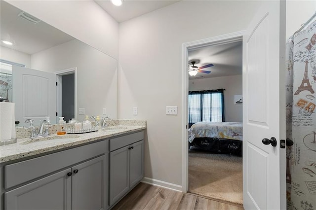 bathroom with vanity, hardwood / wood-style flooring, and ceiling fan