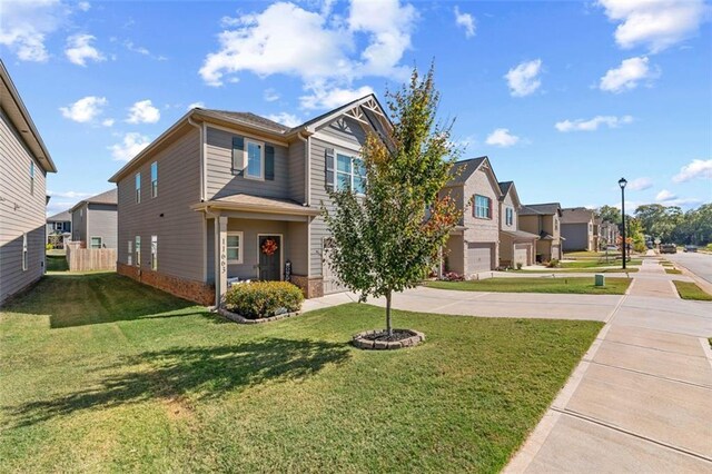 view of front of house featuring a front lawn and a garage