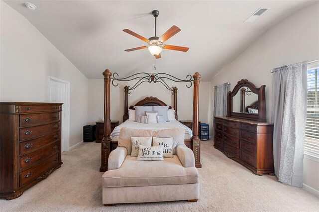 bedroom with ceiling fan, light carpet, and vaulted ceiling