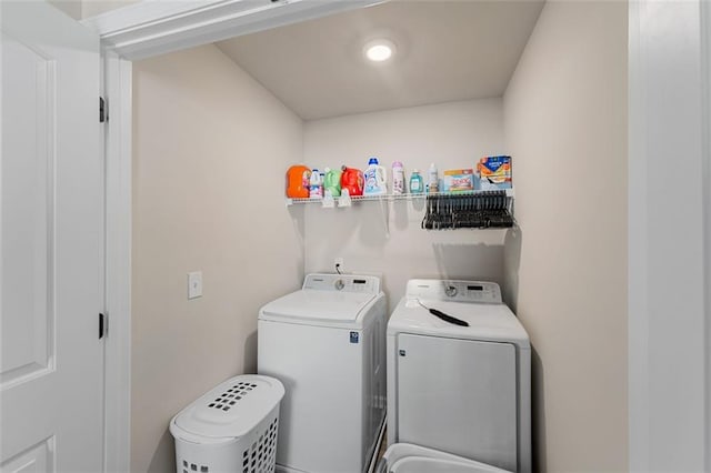 clothes washing area with separate washer and dryer