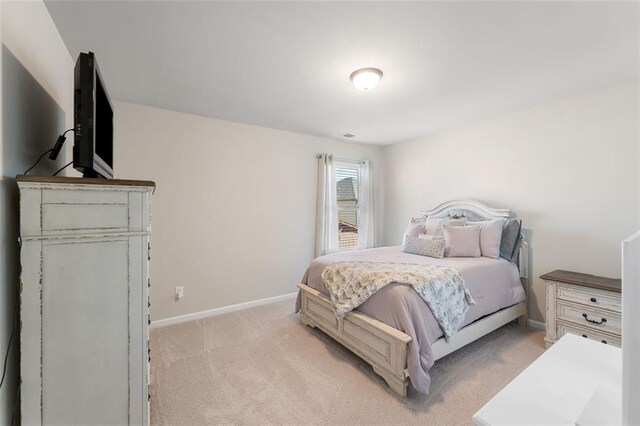 bedroom featuring light colored carpet