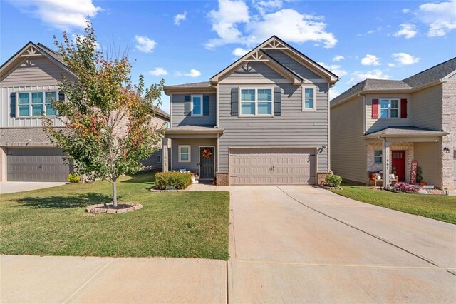 craftsman house featuring a garage and a front lawn