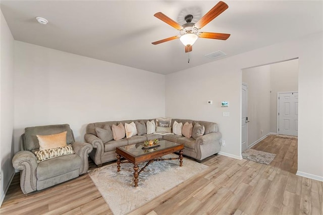 living room featuring light hardwood / wood-style floors and ceiling fan