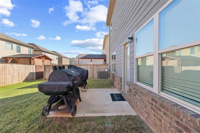 view of yard featuring a patio and central air condition unit