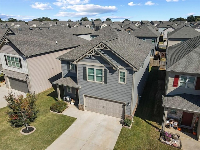 view of front of property with a front yard and a garage