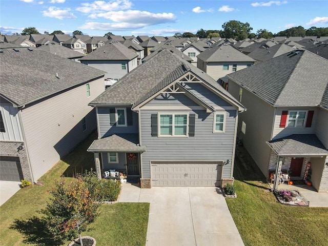 view of front of property featuring a front yard and a garage