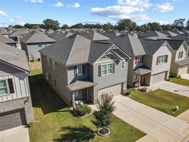 view of front of home with a front yard and a garage