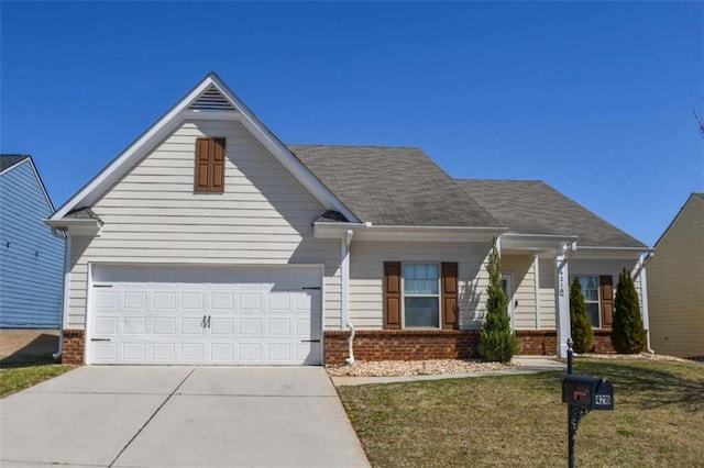 view of front of property featuring brick siding, an attached garage, concrete driveway, and a front yard