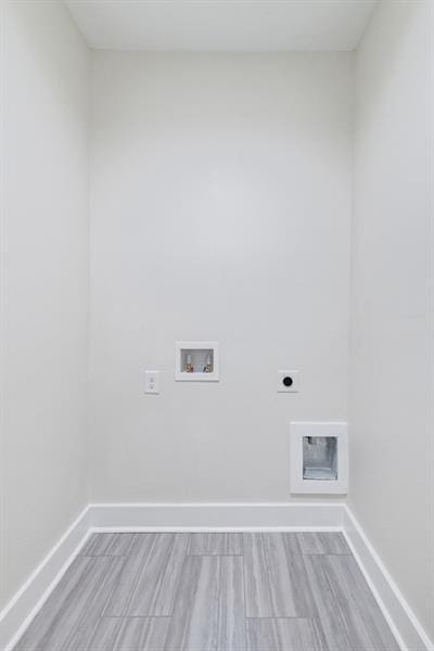 clothes washing area featuring hookup for a washing machine, hookup for an electric dryer, and light hardwood / wood-style floors