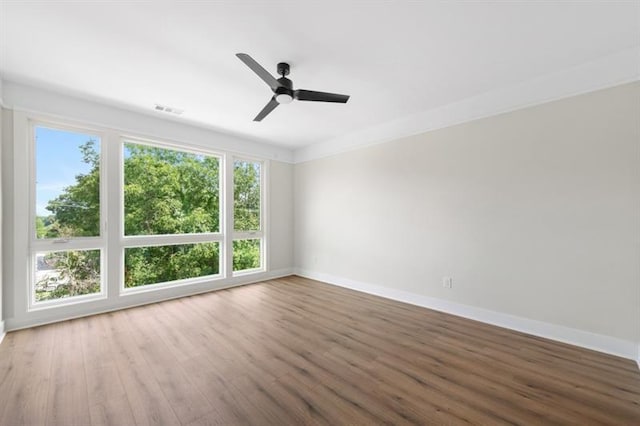 unfurnished room with ceiling fan, ornamental molding, and hardwood / wood-style flooring