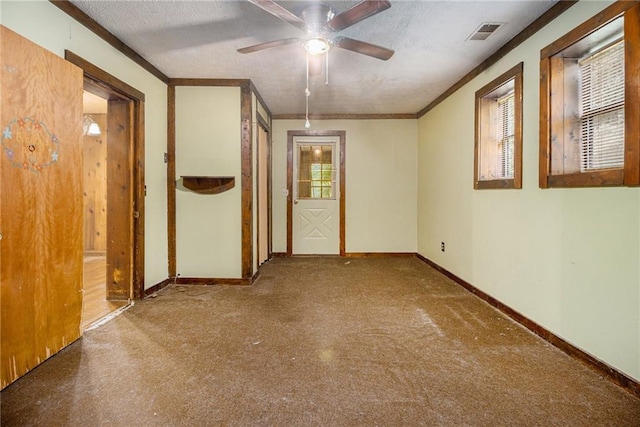 unfurnished room with ceiling fan, crown molding, and a textured ceiling