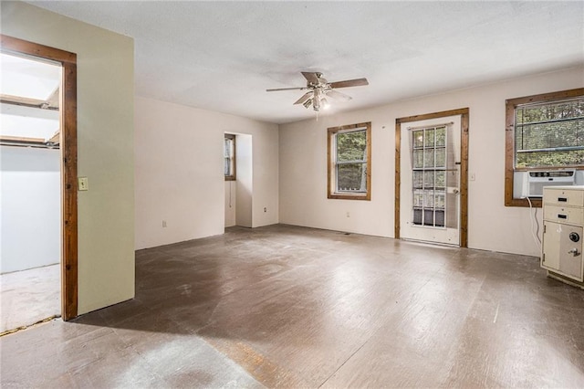 unfurnished room featuring cooling unit and ceiling fan