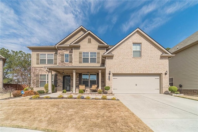 craftsman house with covered porch, an attached garage, concrete driveway, and a front lawn