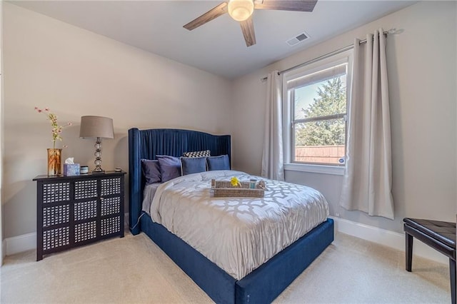 bedroom featuring visible vents, baseboards, light colored carpet, and ceiling fan