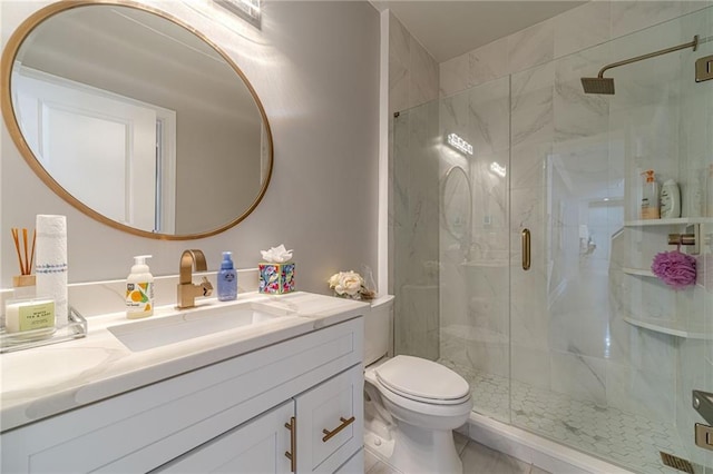 full bath featuring vanity, toilet, and a marble finish shower