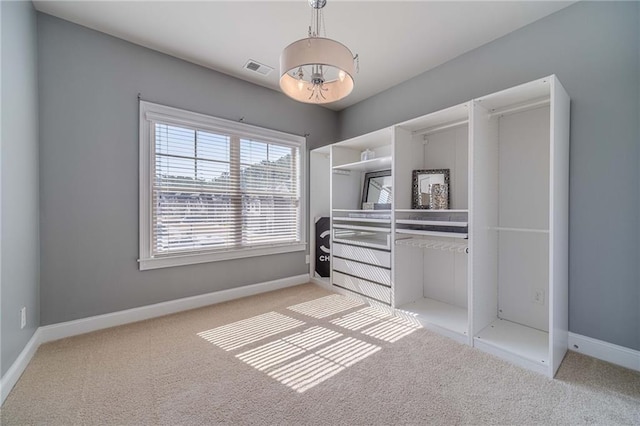 spacious closet with carpet flooring and visible vents