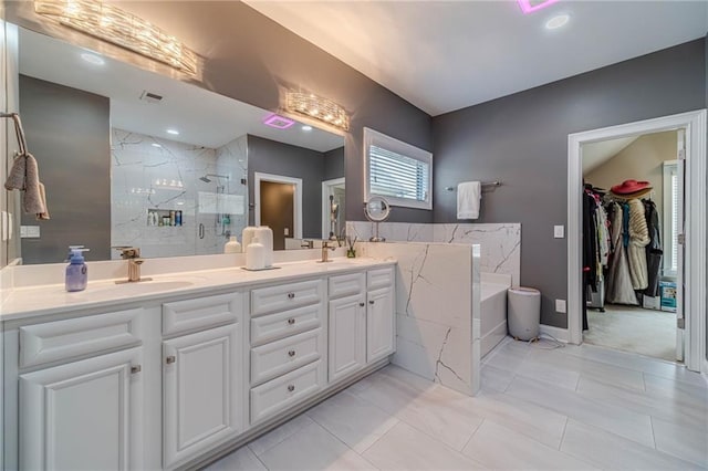 full bathroom featuring visible vents, double vanity, a stall shower, a sink, and a bath