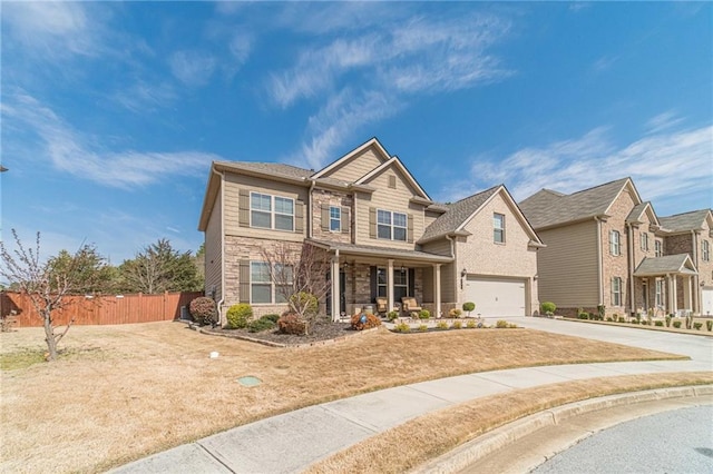 craftsman house with fence, a porch, concrete driveway, a garage, and stone siding